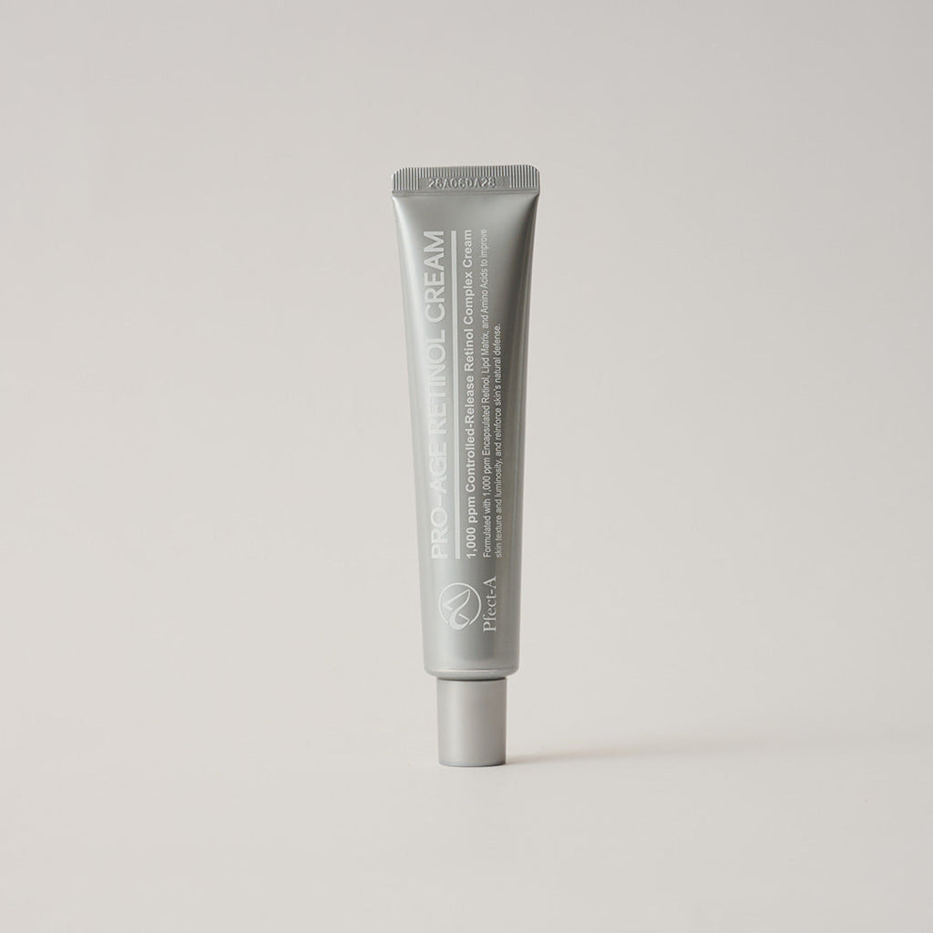 Pfect-A ProAge Controlled Release Retinol Cream 1,000ppm in a sleek silver tube — anti-aging retinol cream with peptides and hyaluronic acid for fine lines and firmness, on a neutral background