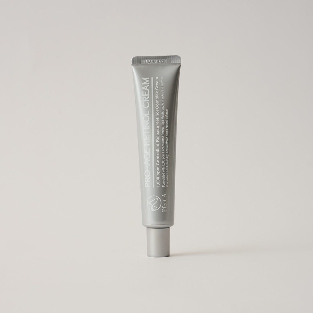Pfect-A ProAge Controlled Release Retinol Cream 1,000ppm in a sleek silver tube — anti-aging retinol cream with peptides and hyaluronic acid for fine lines and firmness, on a neutral background